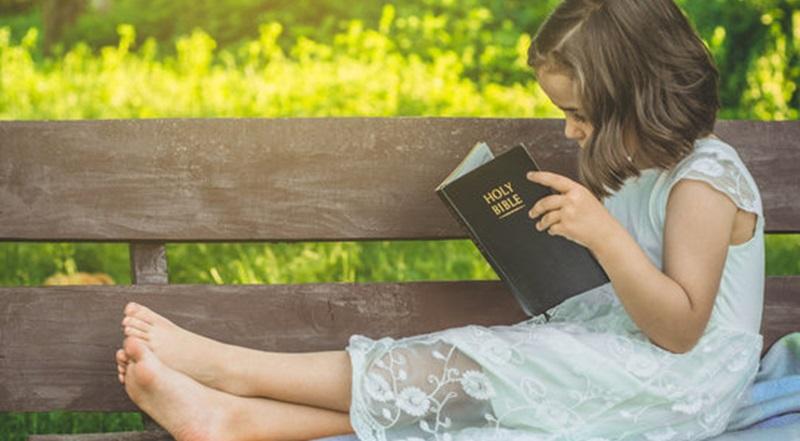 child reading Bible