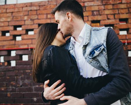 man kissing women